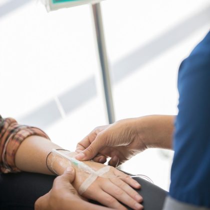 Doctor administering infusion to patient